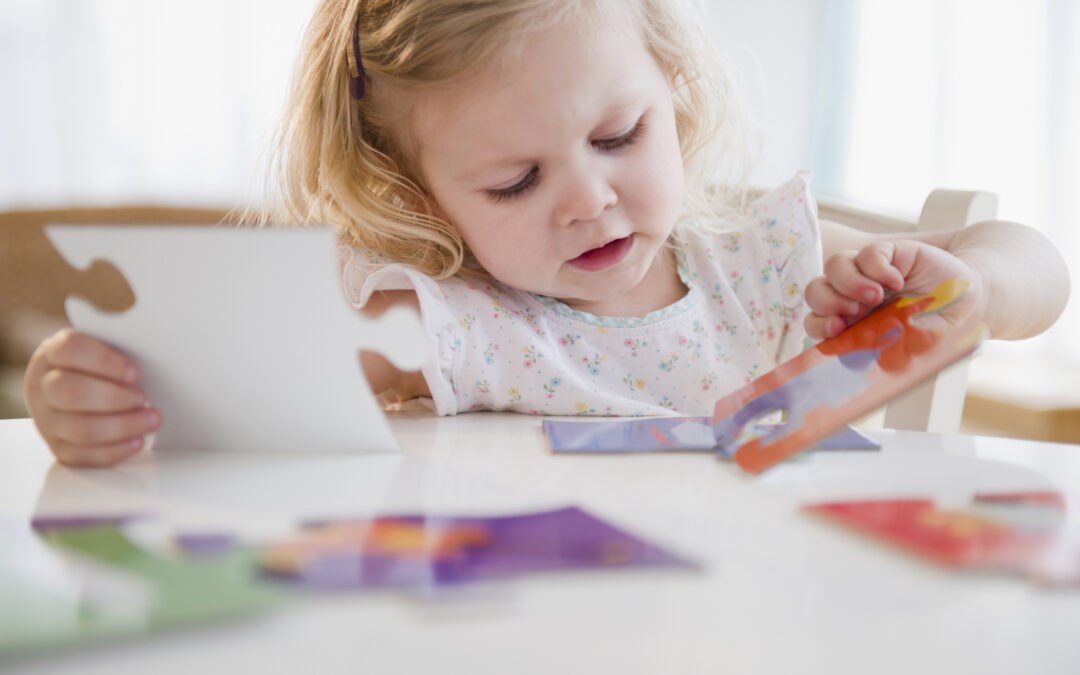Toddler learning early coding skills using puzzle