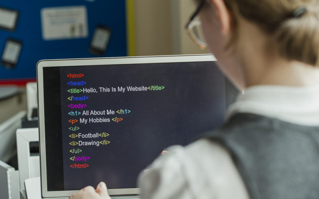 Watching over shoulder as female student learns to code on computer