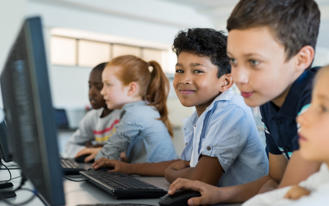 K-12 students applying learning about technology in computer lab
