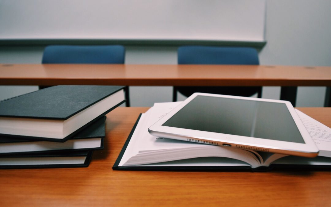 computer tablet on books