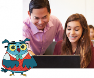 Female high school student learning digital literacy skills on computer with teacher pointing at computer screen and scholastic owl in foreground